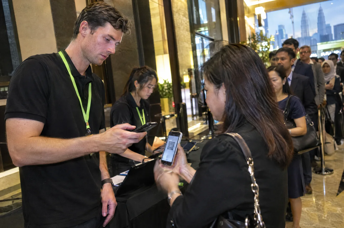 A crew member scanning a guest's QR ticket at the entrance